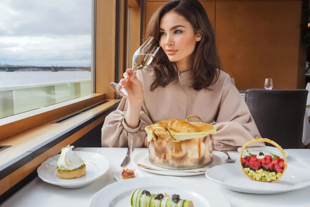 Personne dégustant repas raffiné avec vue sur pont, image illustrant l’expérience culinaire locale loin des pièges à touristes.